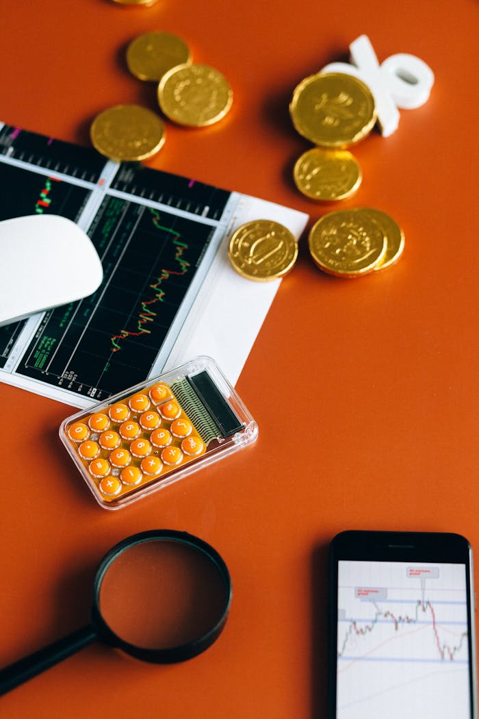 get-in-touch Stock market and financial analysis setup with calculator, graphs, and gold coins.